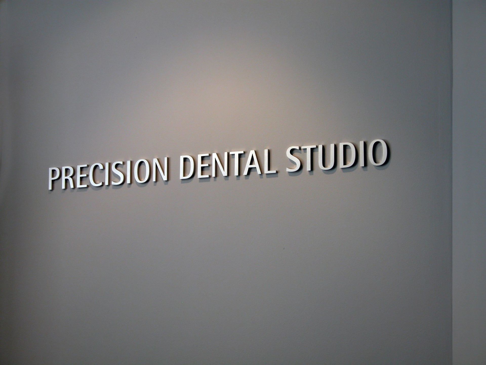 8mm thick router cut sprayed acrylic letters mounted directly onto internal wall of reception area
