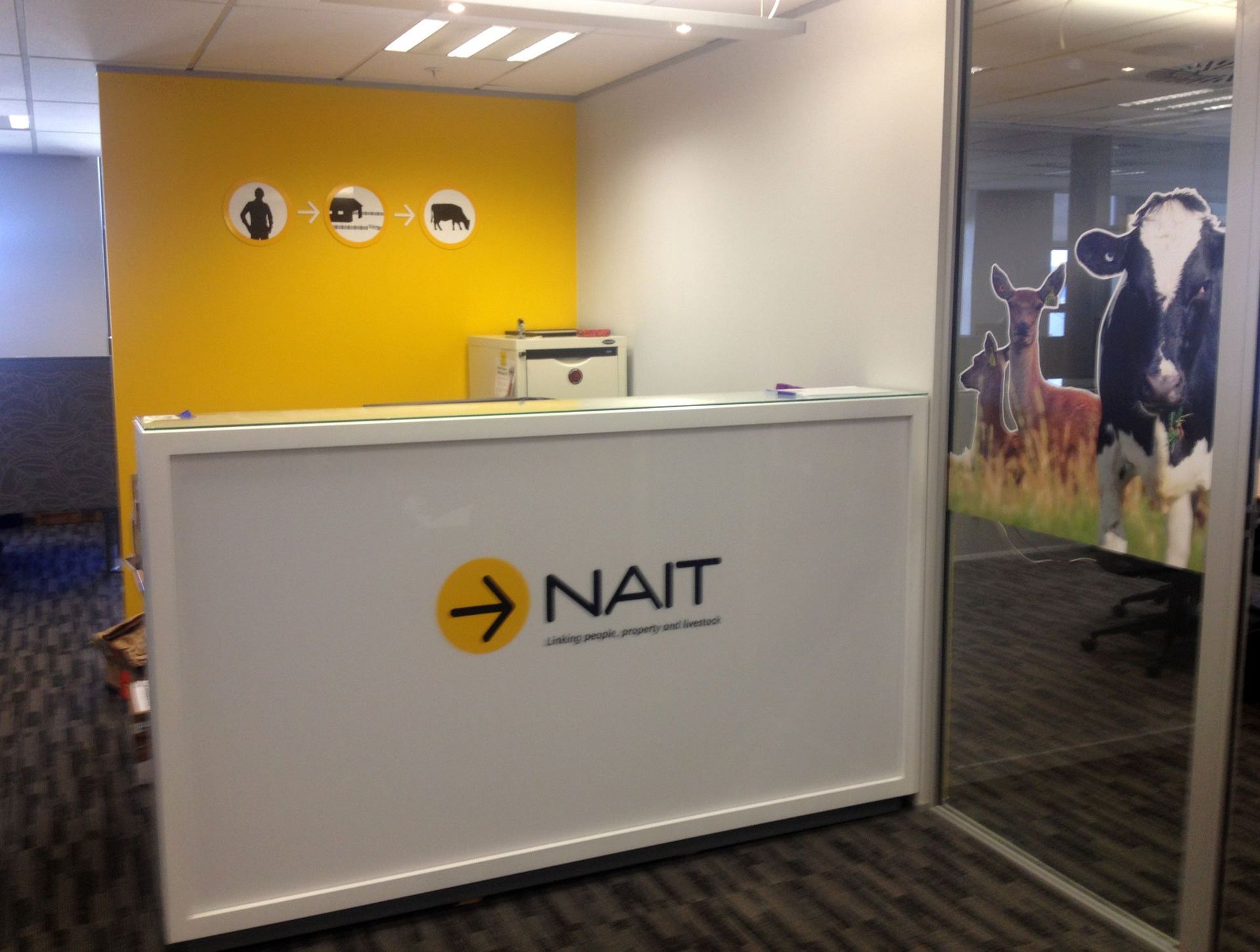 Acrylic circles on wall. Vinyls on reception counter and graphics applied to glass