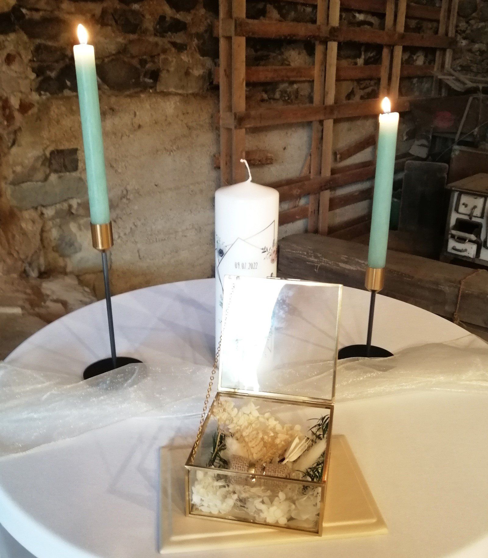 Ein Tisch mit zwei Kerzen und einer Schachtel darauf