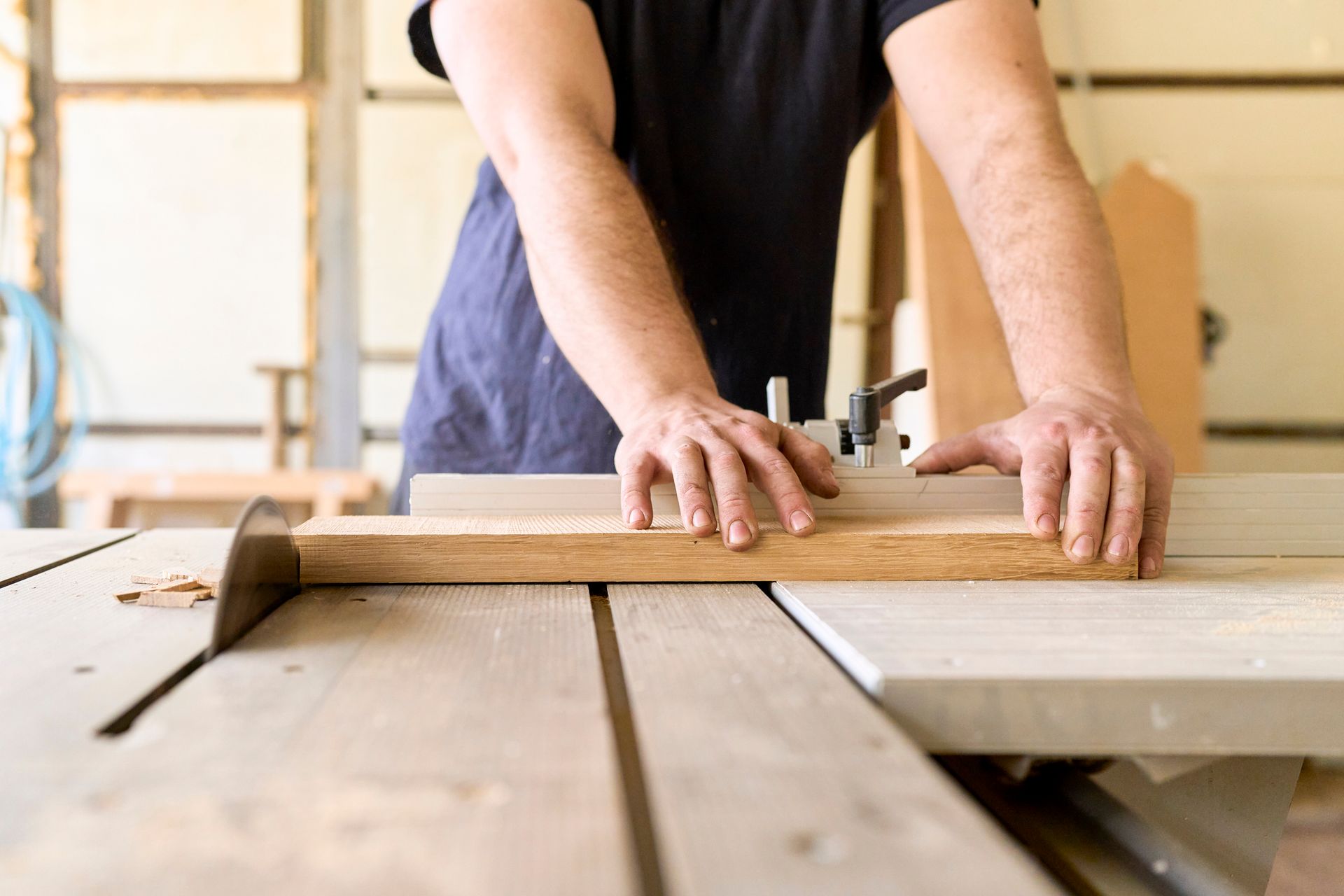 A wooden deck with stairs and a bench in the backyard of a house.