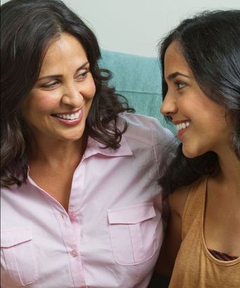 Mom and daughter foreheads together