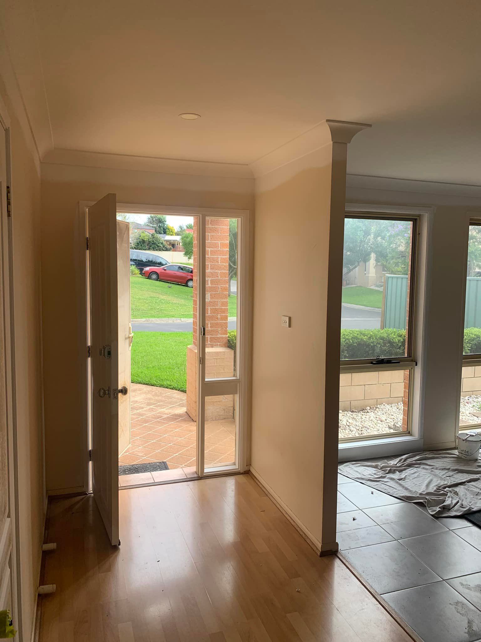A Living Room With Hardwood Floors and a Sliding Glass Door — Karl Witt Painter & Decorator In Albion Park, NSW