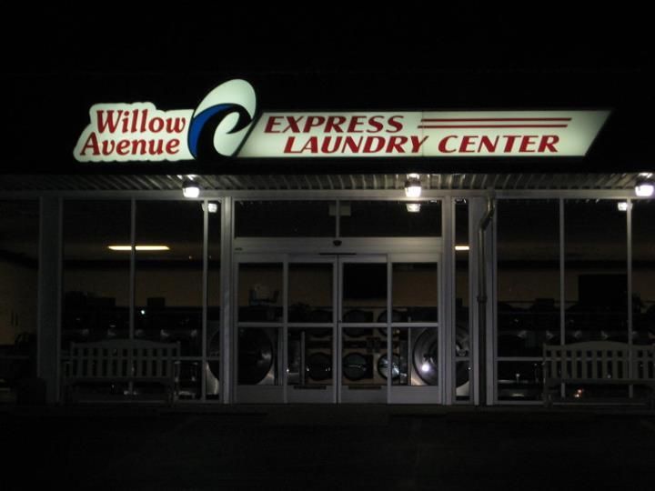 The willow avenue express laundry center is lit up at night