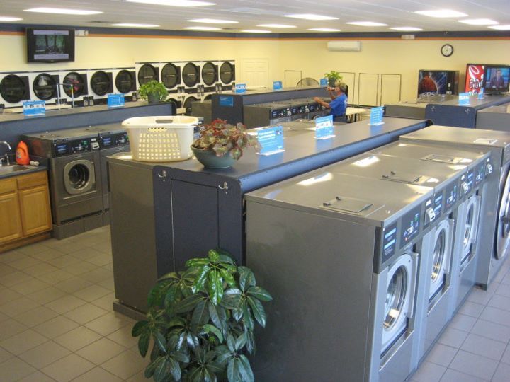 A laundromat with lots of washers and dryers