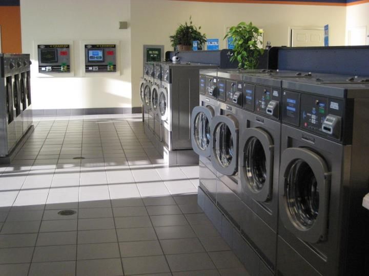 A laundromat with a lot of washers and dryers