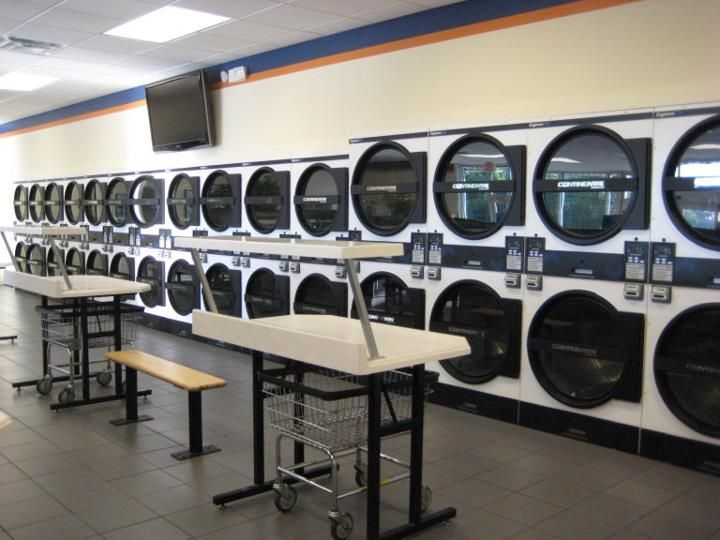 A laundromat with lots of washers and dryers