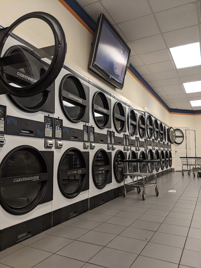 A laundromat with a lot of washers and dryers
