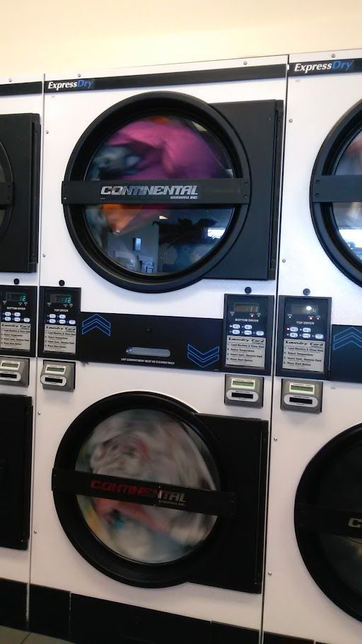 A laundromat with a lot of washers and dryers.