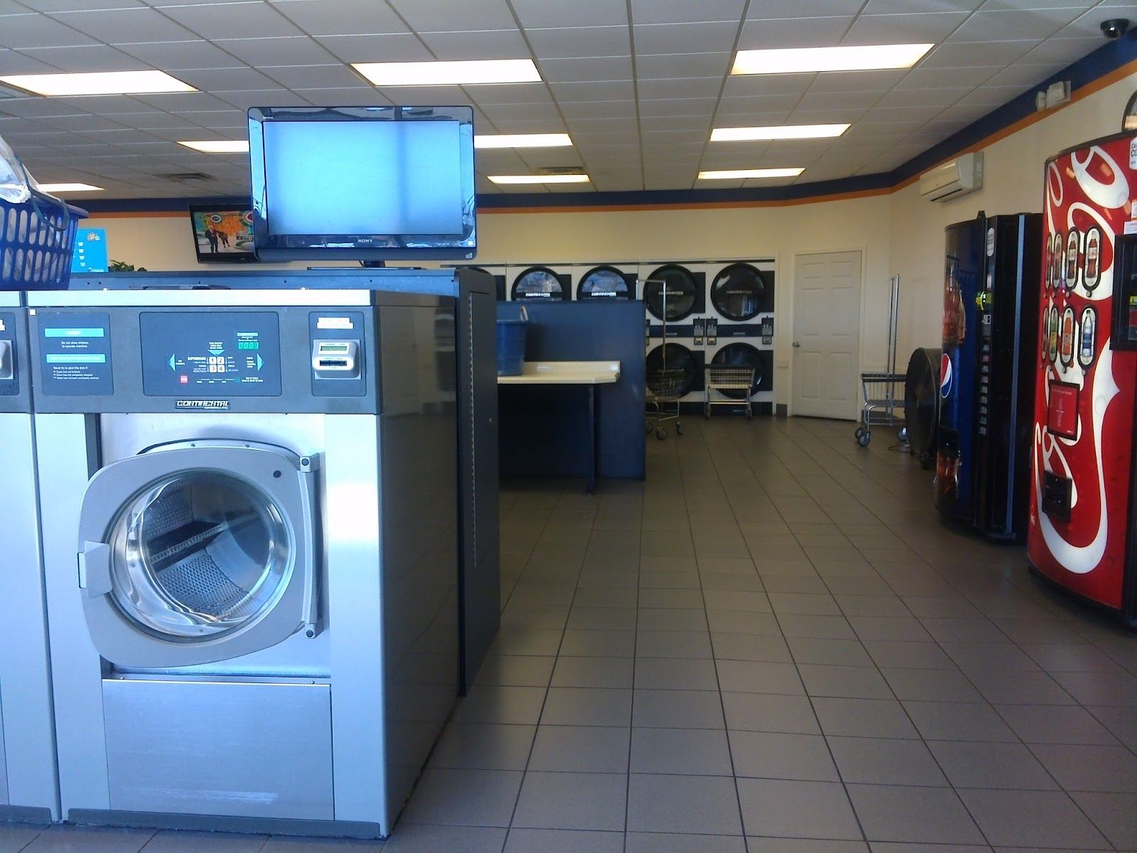 A laundromat with a vending machine that says coca cola