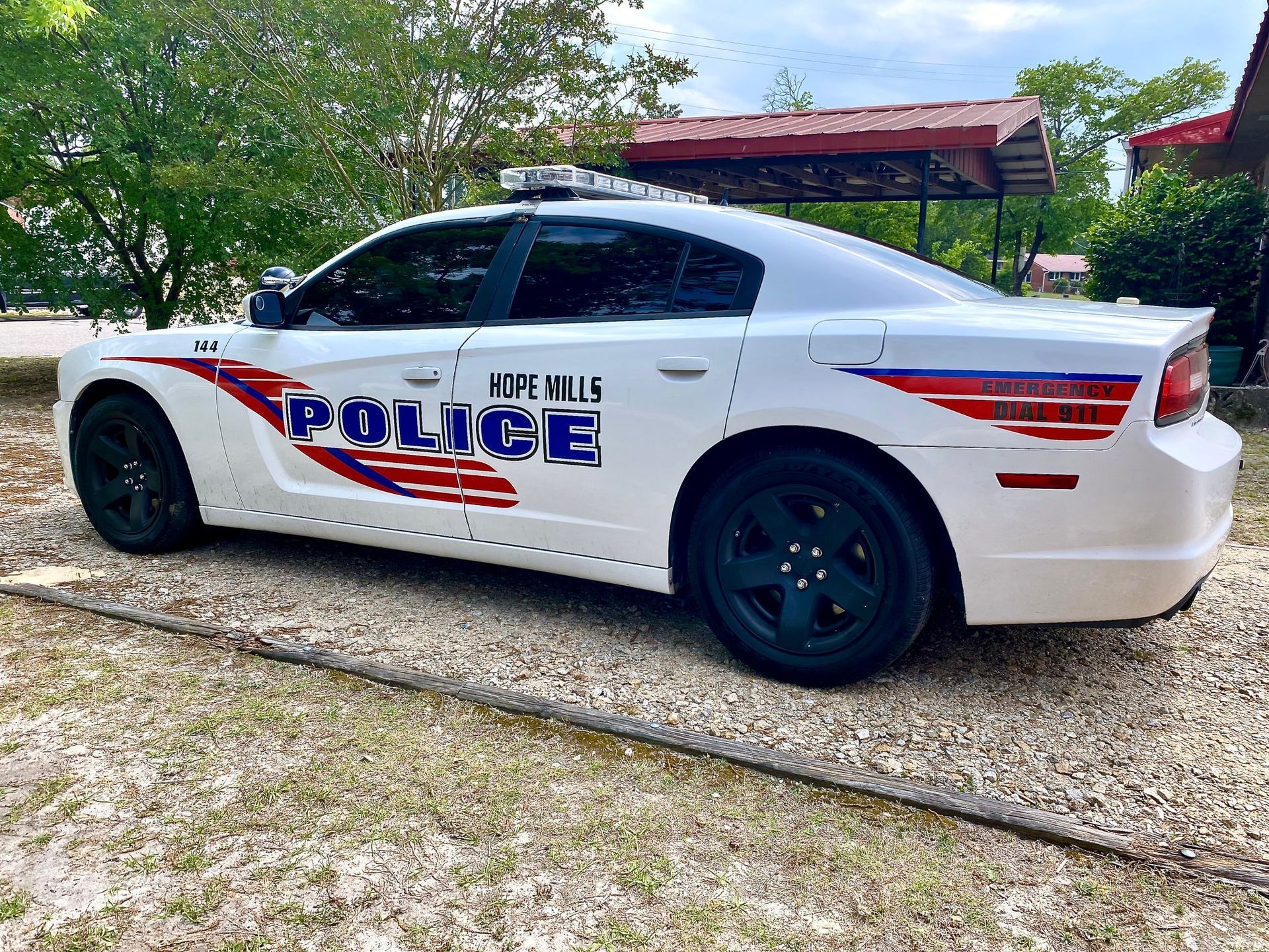 A white Dodge Charger patrol car labeled 
