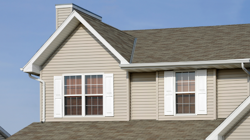 A house with a brown roof and white shutters