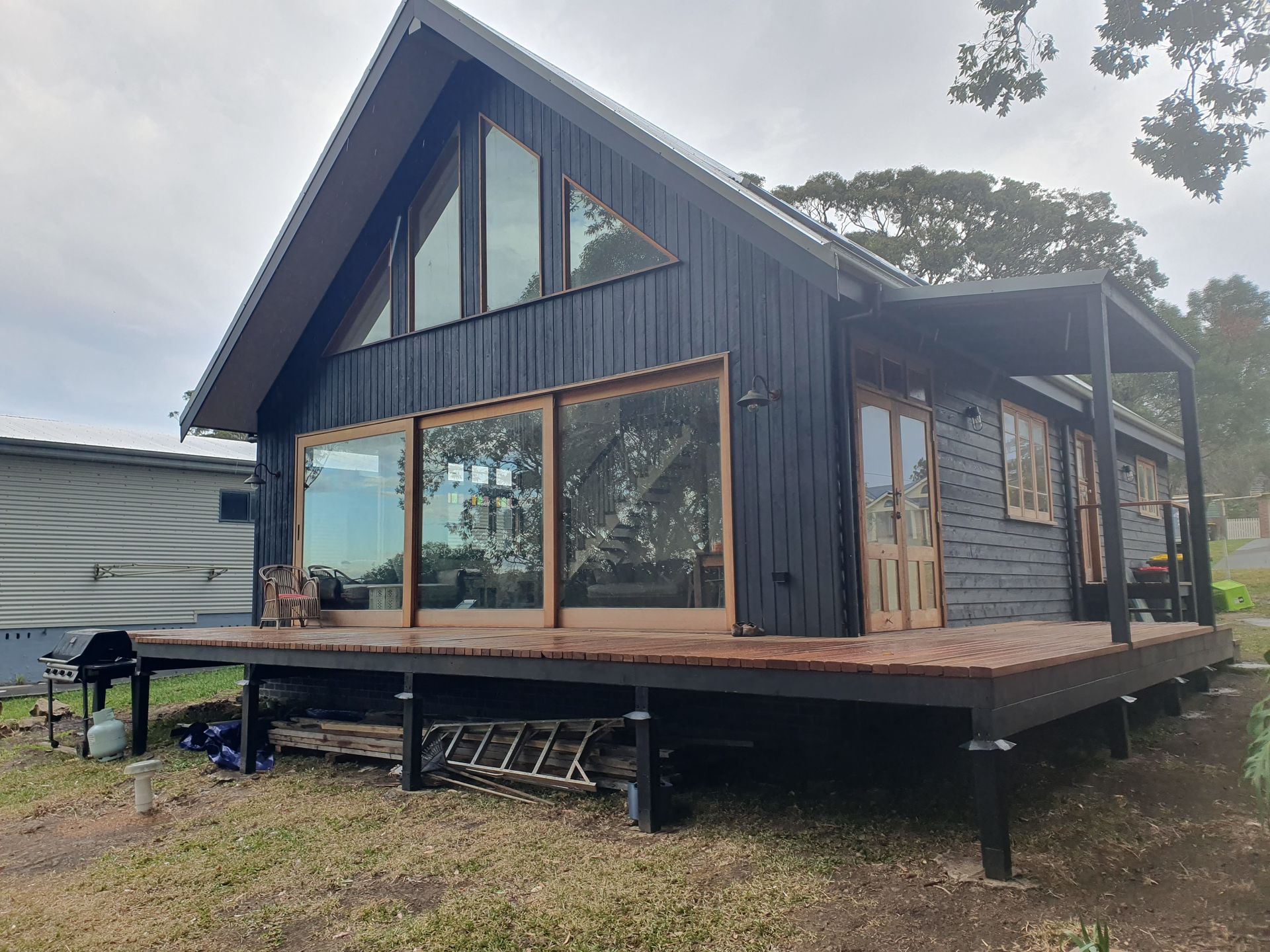 Modern kitchen with dark wood cabinets, marble countertops, and accent lighting.