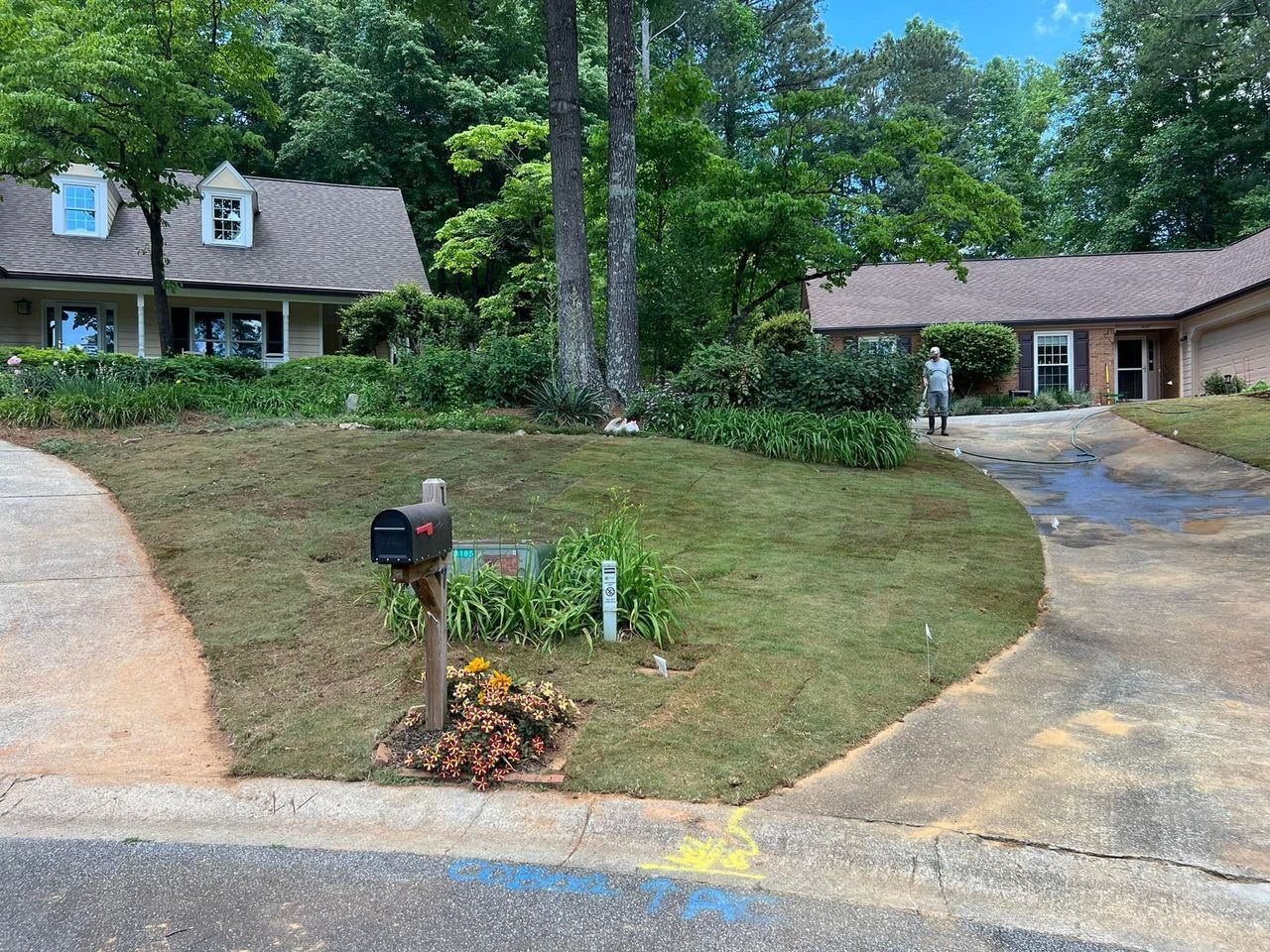 A large house with a mailbox in front of it.