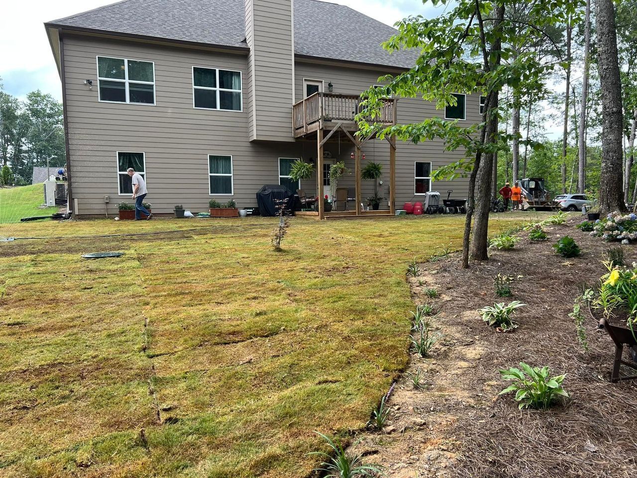 A large house with a large lawn in front of it.
