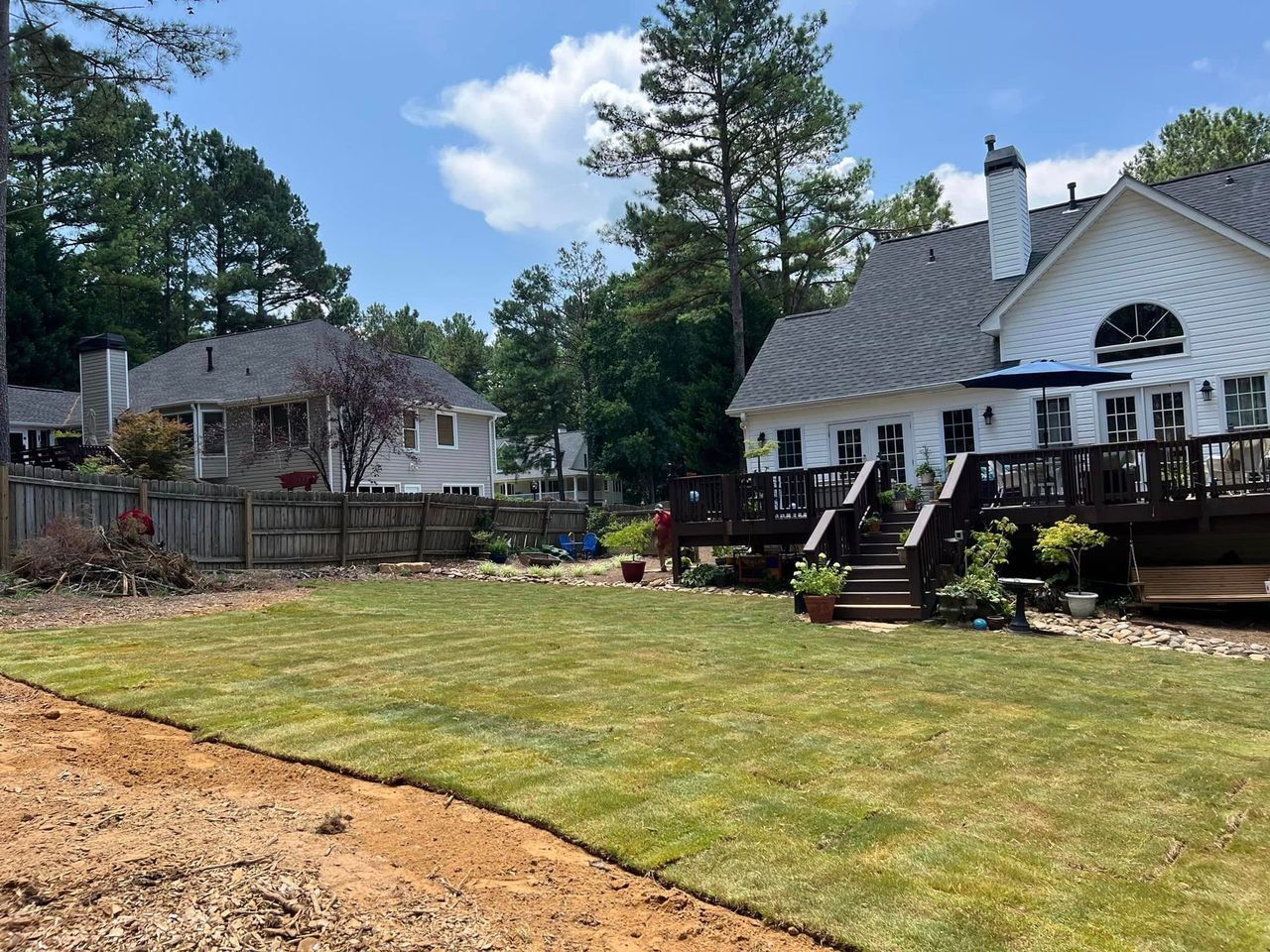 A large white house with a large lawn in front of it.