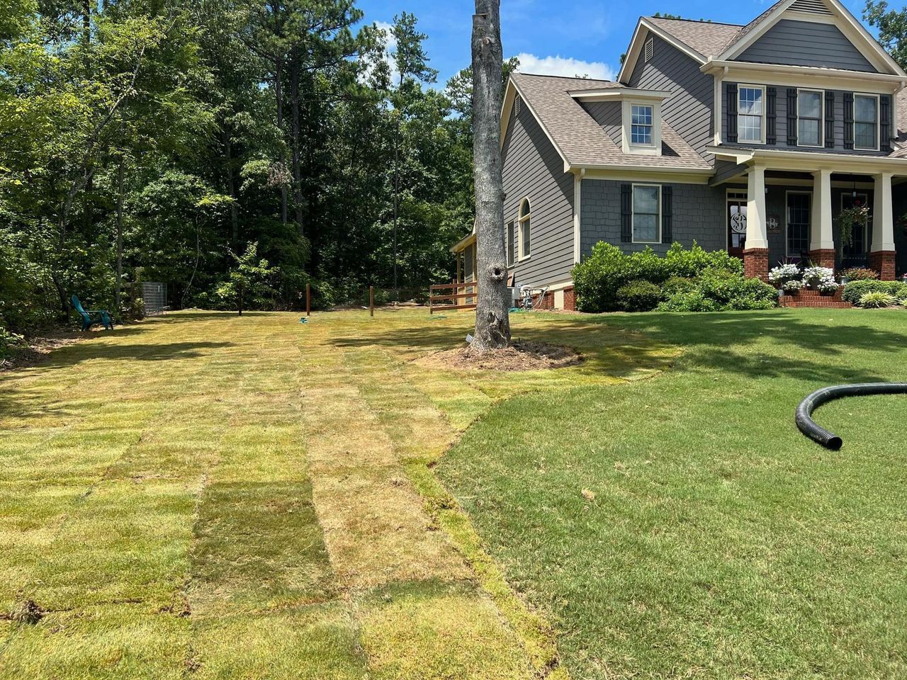 A large house with a lush green lawn in front of it.