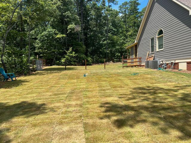 A house with a large lawn in front of it.