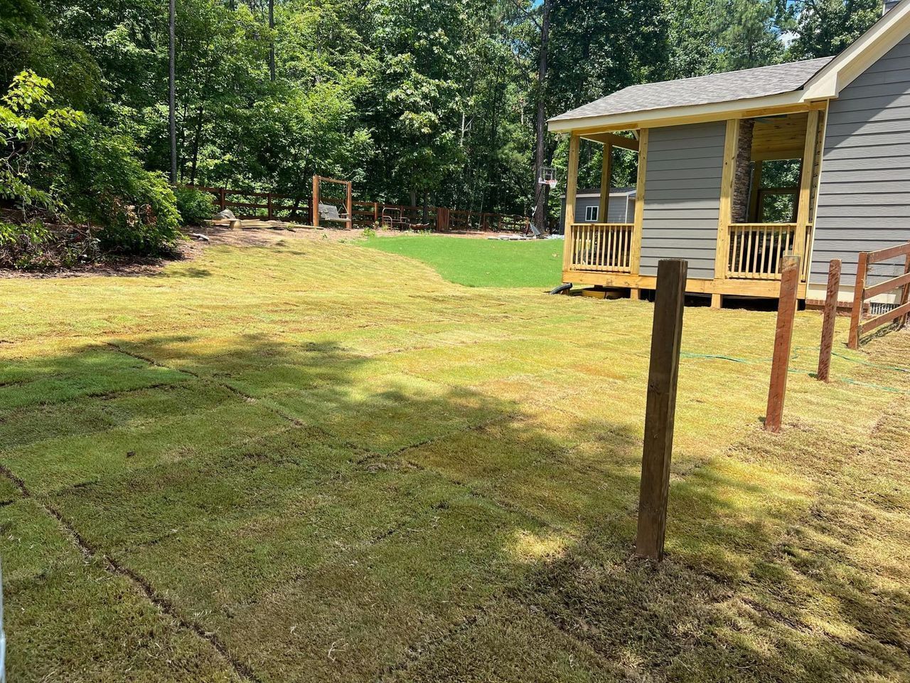 A house with a porch and a gazebo in the backyard.