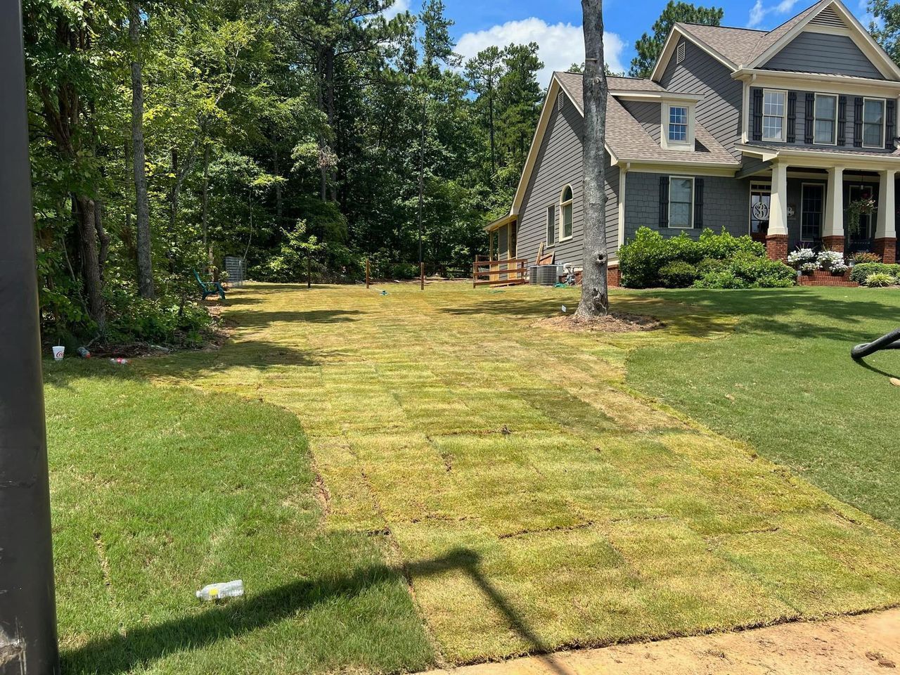 A large house with a lush green lawn in front of it.
