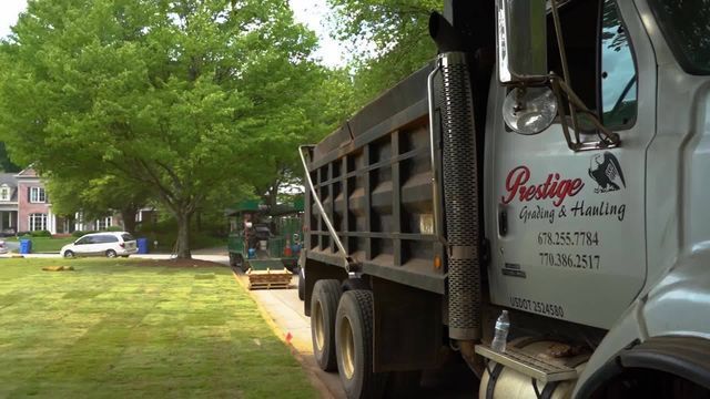 A dump truck is parked on the side of the road.
