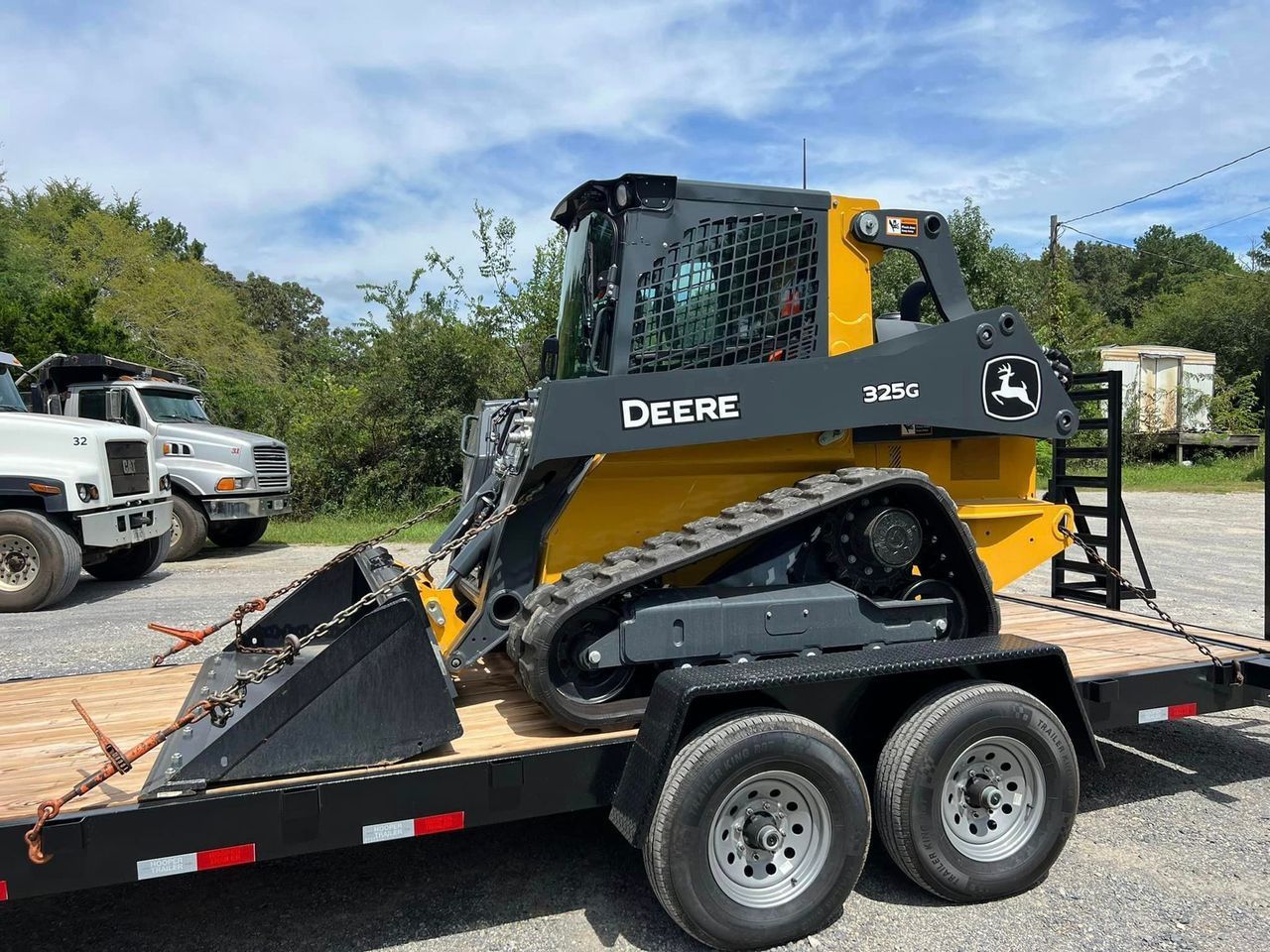 A bulldozer is sitting on top of a trailer.