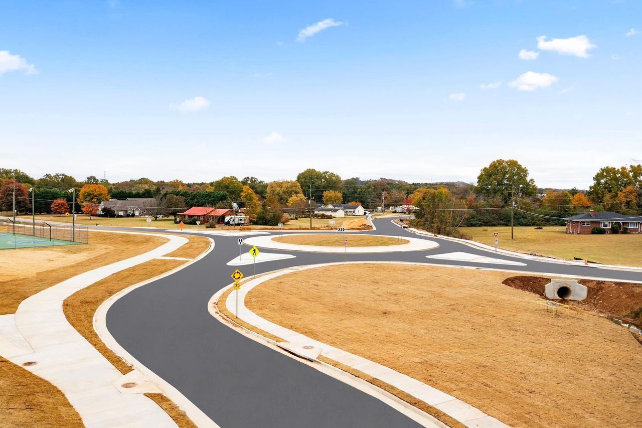 An aerial view of a curvy road in a residential area.