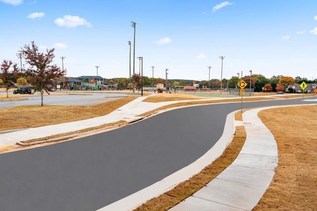 A road with a sidewalk on the side of it