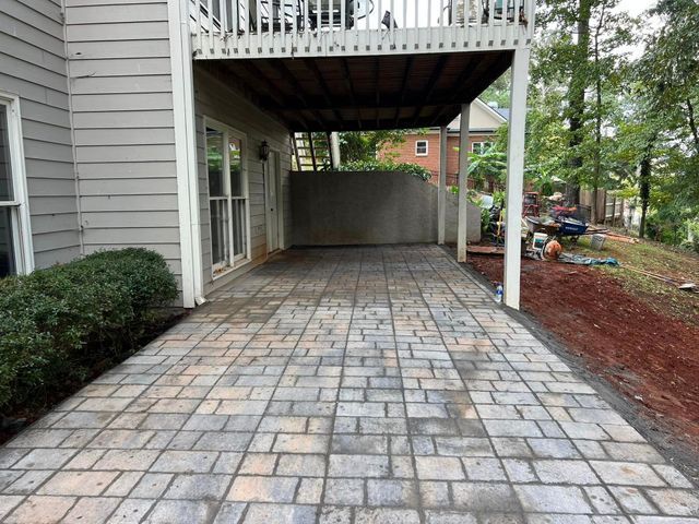 A patio is being built in front of a house.