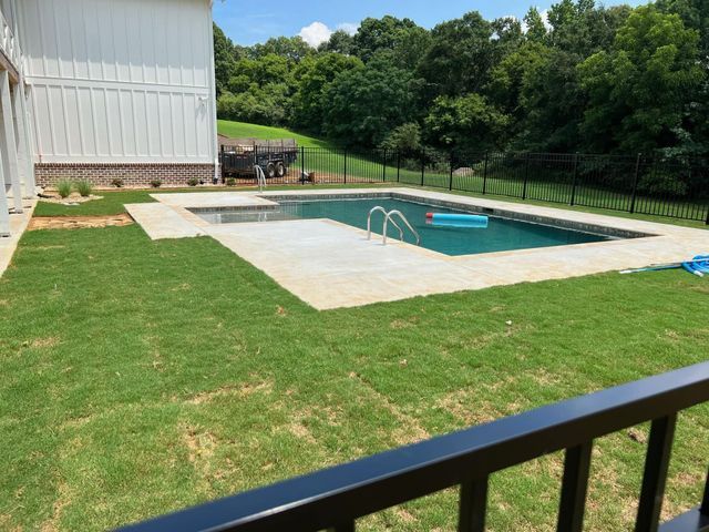 A large swimming pool in the backyard of a house