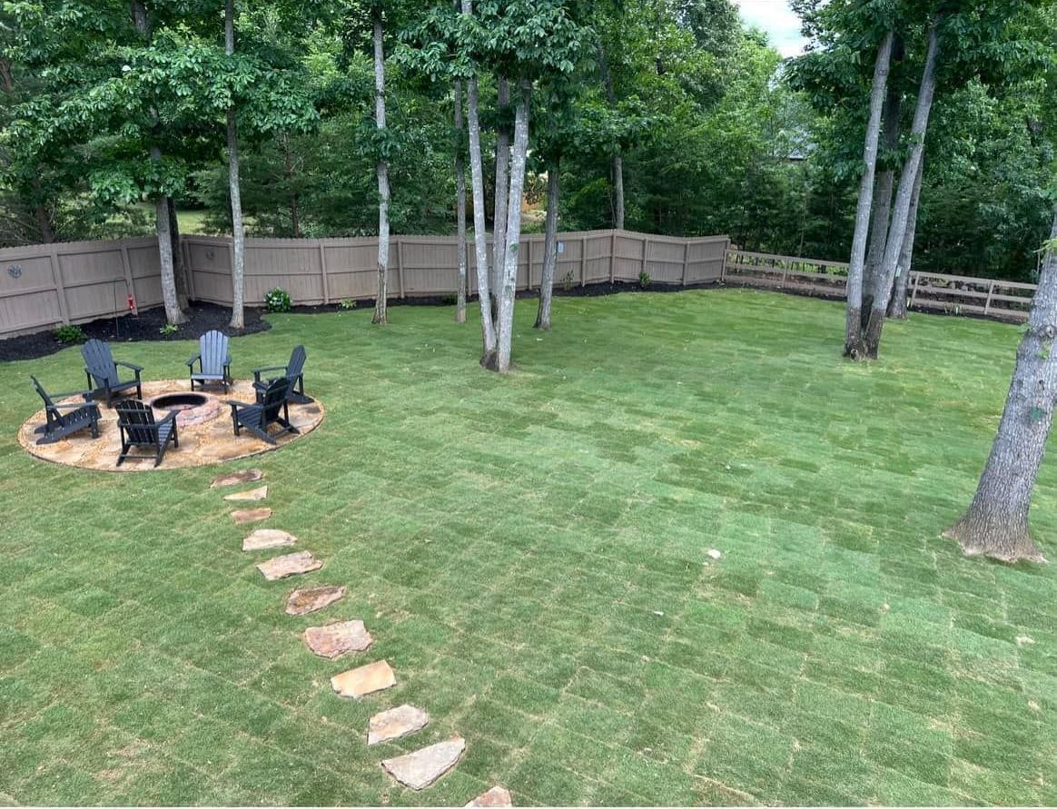 There is a fire pit in the middle of the backyard.
