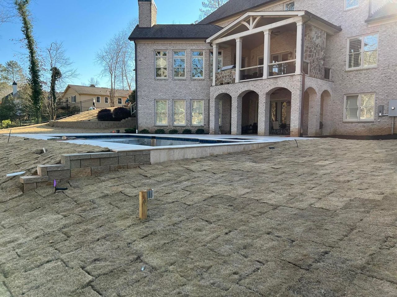 A large house with a pool in the backyard is being built.
