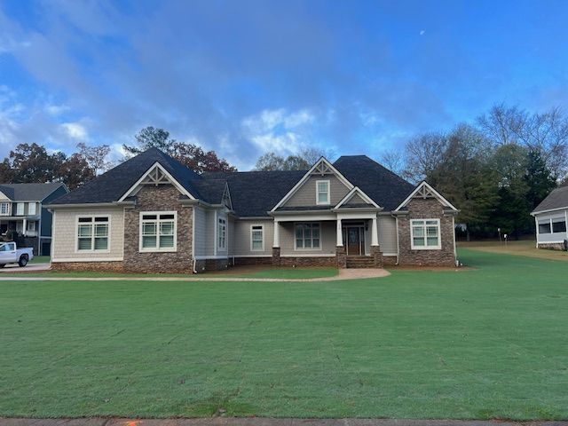 A large house with a large lawn in front of it.