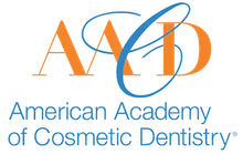 The American Academy of Cosmetic Dentistry logo, featuring the orange letters 