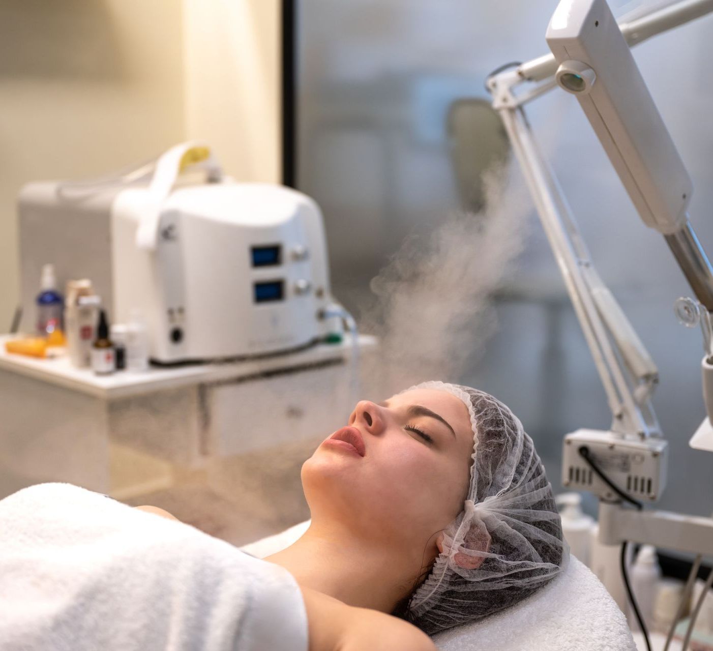 A woman is laying on a bed with a hair net on her head