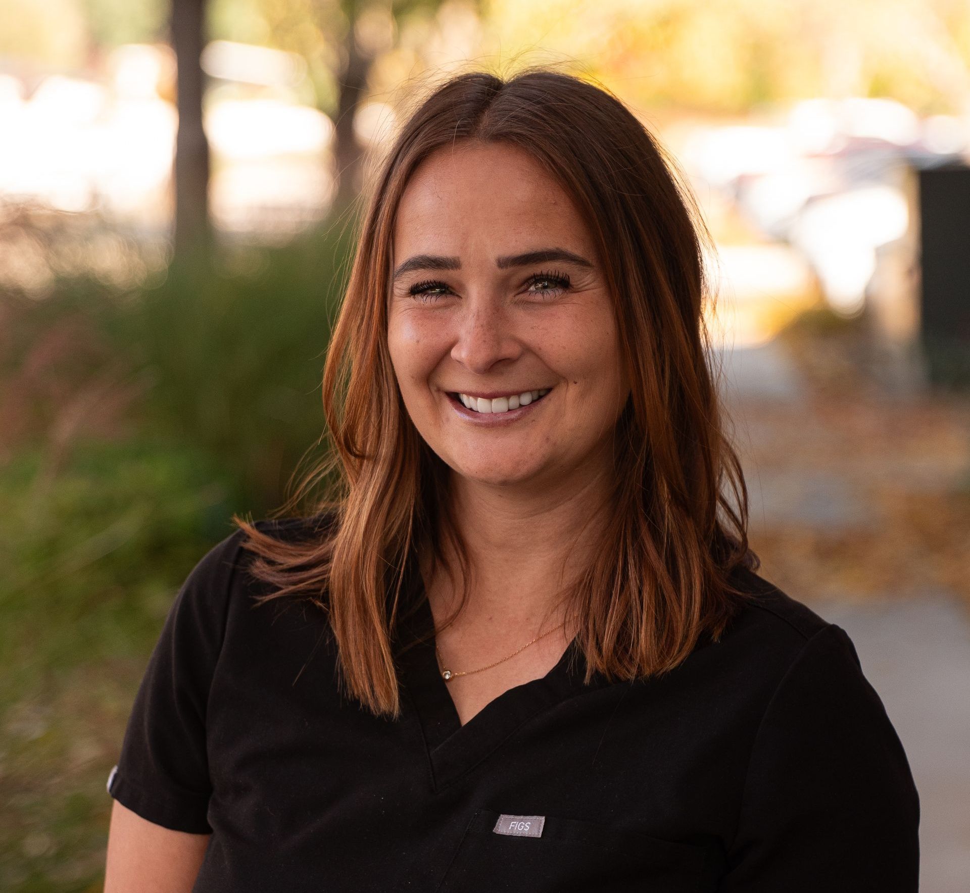 Get holistic care from our biological dentist boise id A woman in a black scrub top is smiling for the camera.