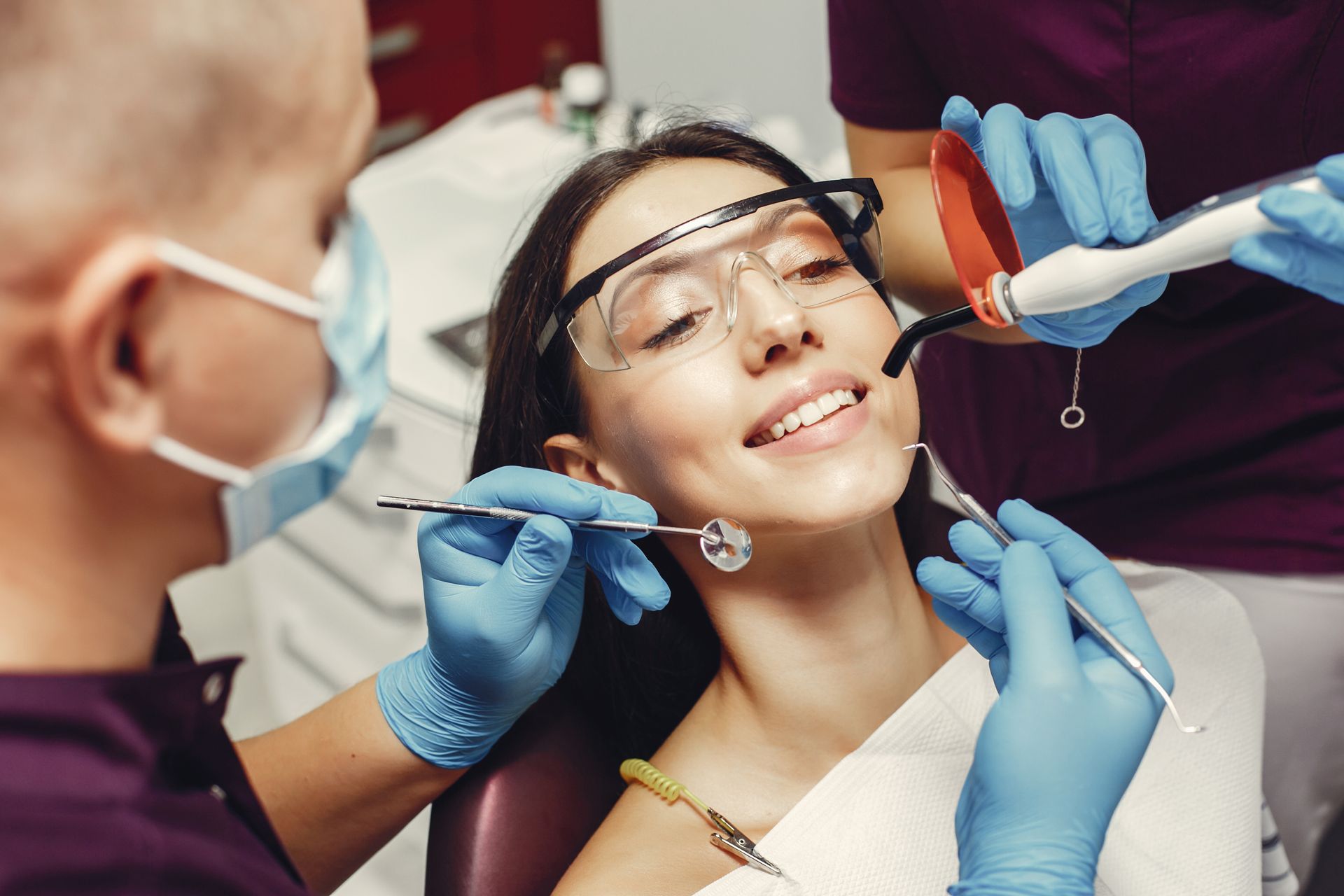 A woman examining her teeth by best dentist in Boise ID