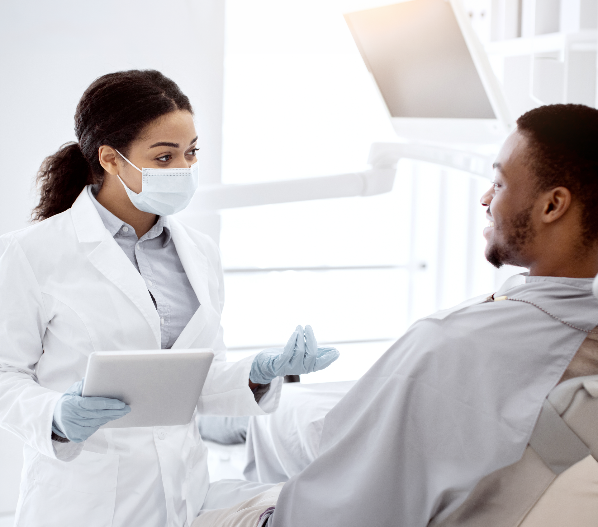 A woman in a bathrobe is sitting in a chair with a syringe in her arm.