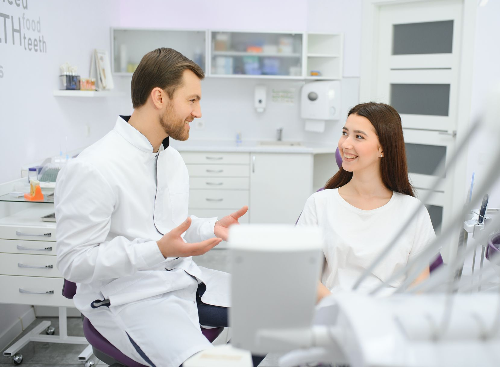 A woman in a bathrobe is sitting in a chair with a syringe in her arm.