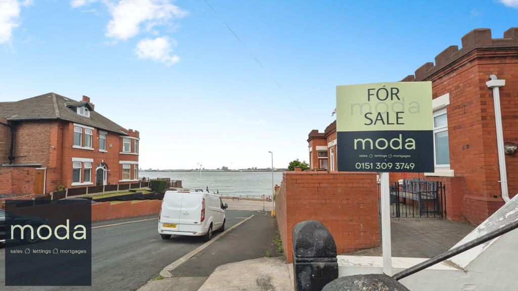 Houses for sale by the water; sign for 