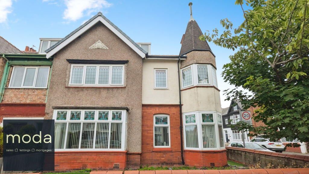 Exterior of a two-story house with a turret, brickwork, and a 