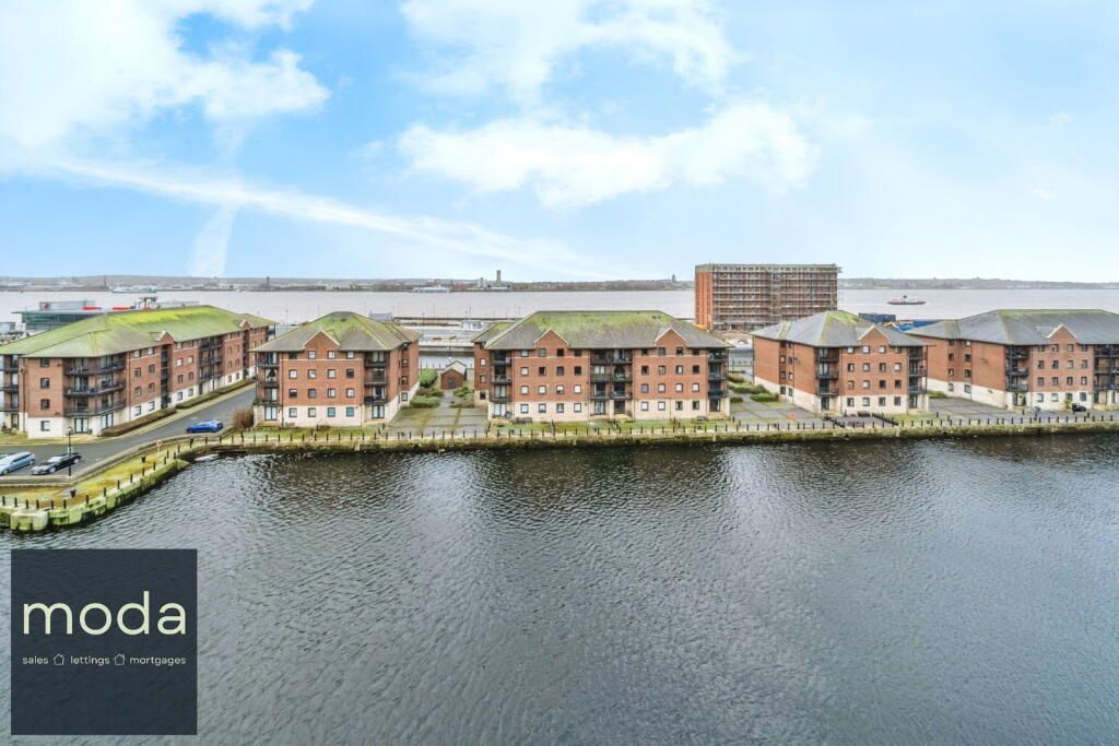 Waterfront apartments with red brick exteriors; MODA logo in foreground.