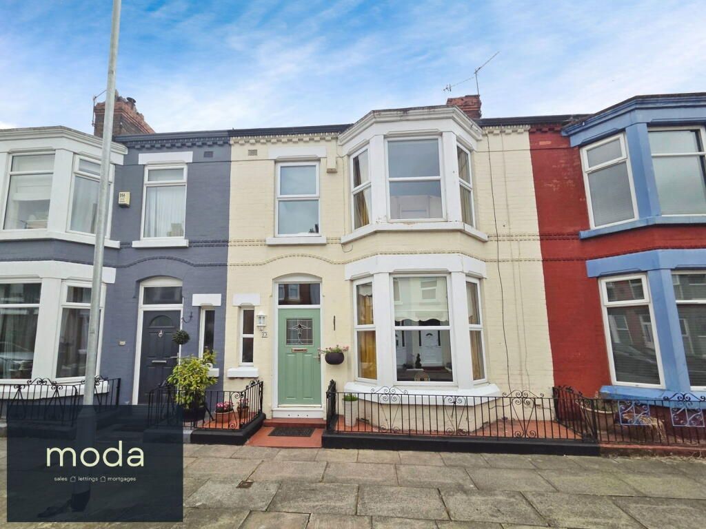 Row of colorful terraced houses with bay windows.
