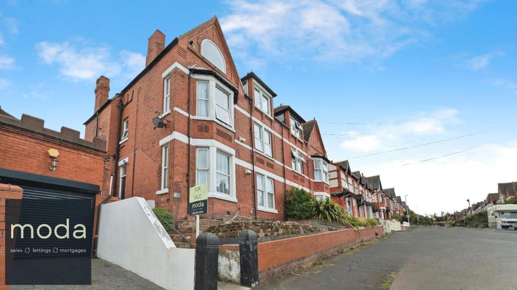 Red brick building with bay windows; 