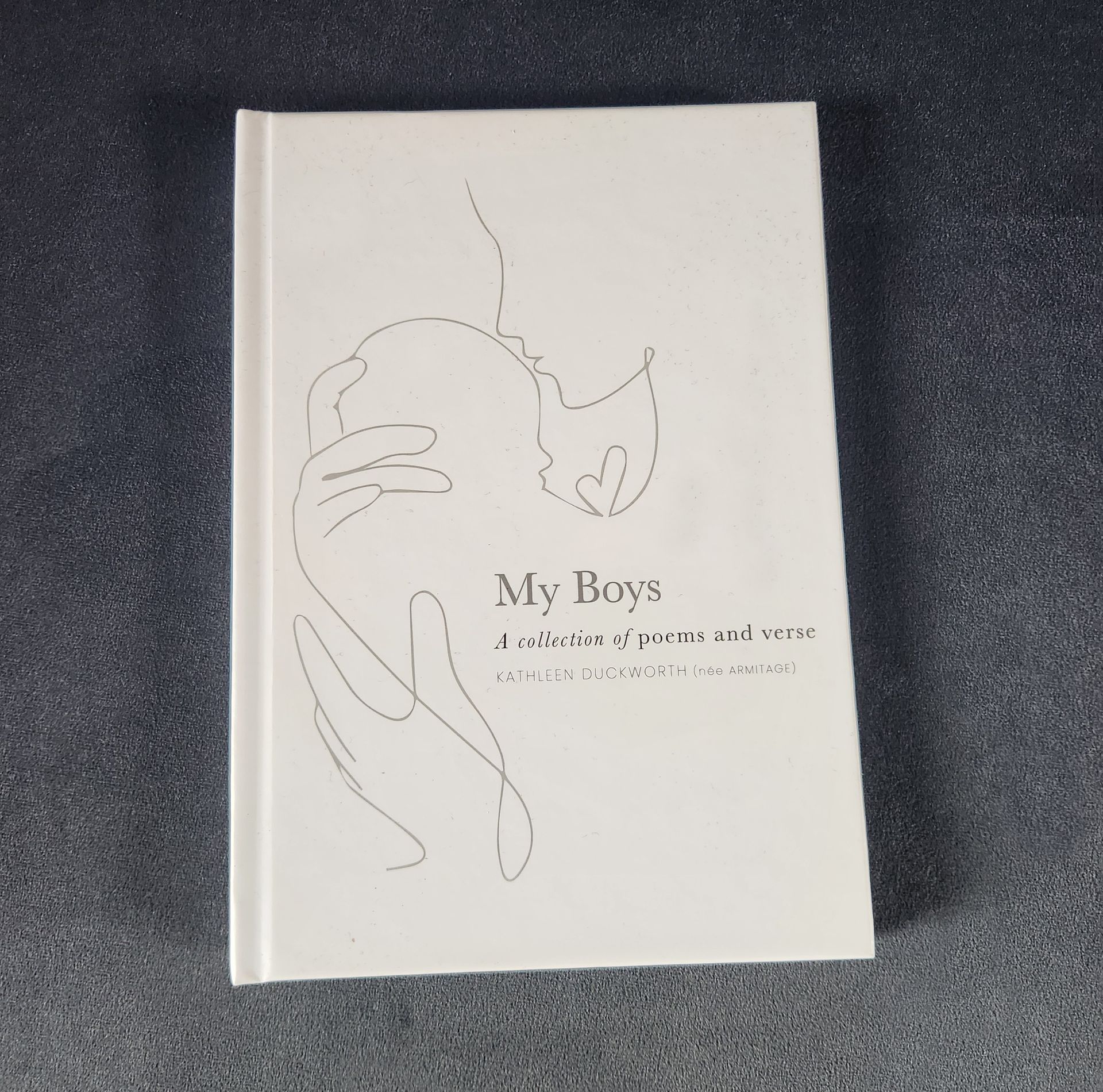 Minimal white book cover with line art face and the title “My Boys” in the center.