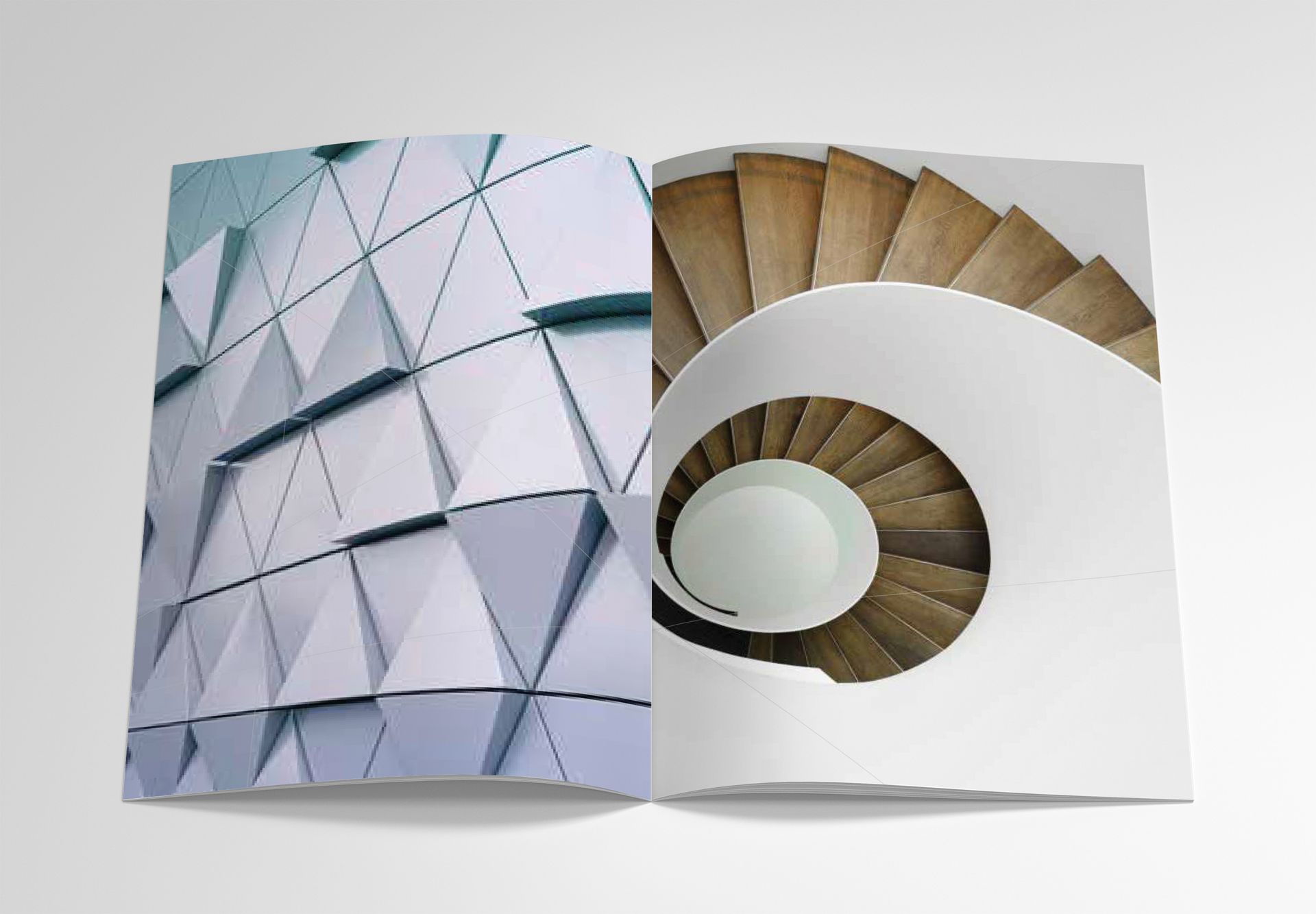 Open book with geometric blue facade and a spiral staircase interior on white background