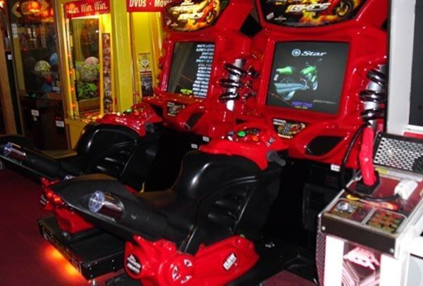 A row of red and black motorcycle arcade games