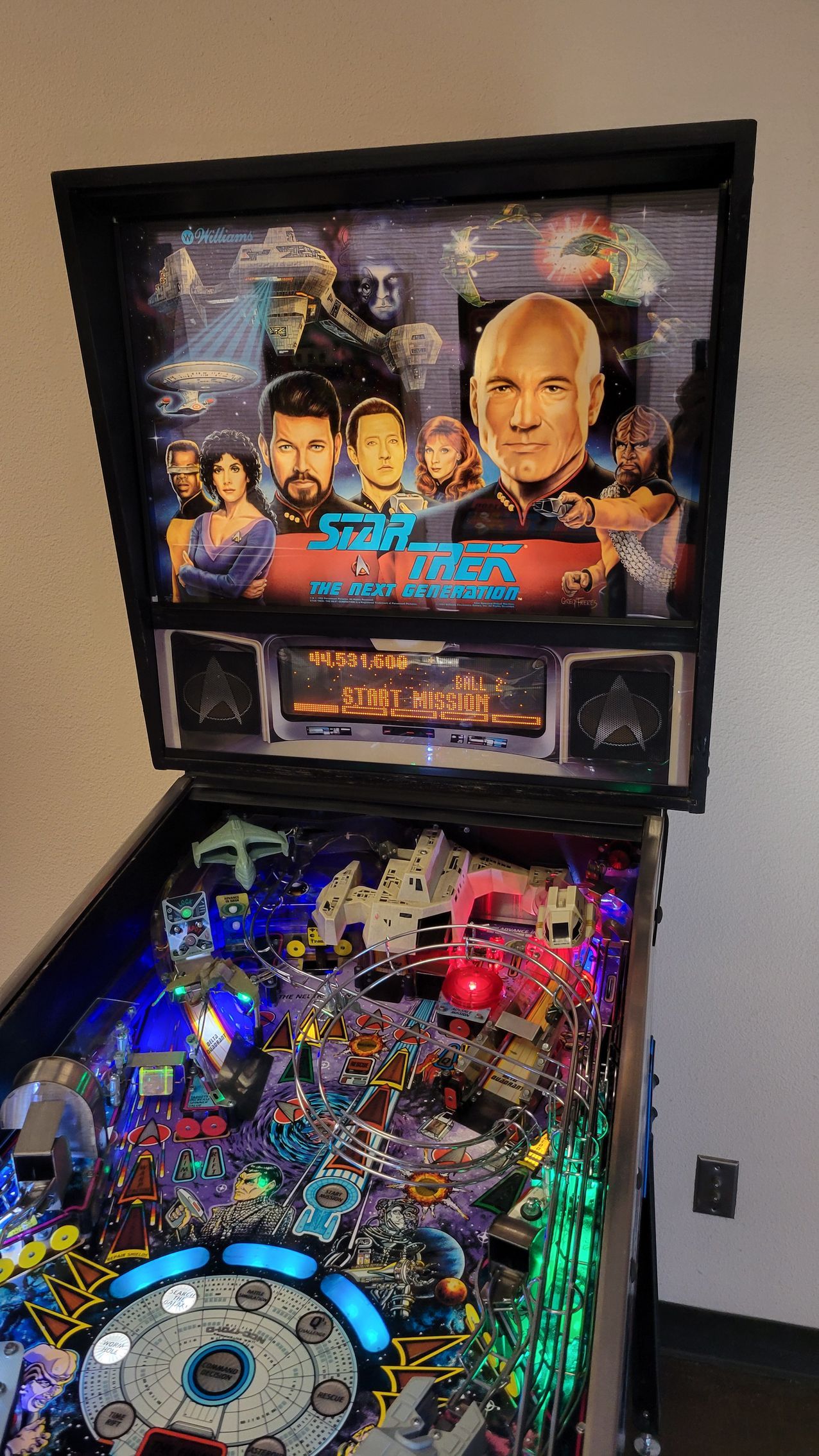 A pinball machine with a star trek theme is sitting on a table.
