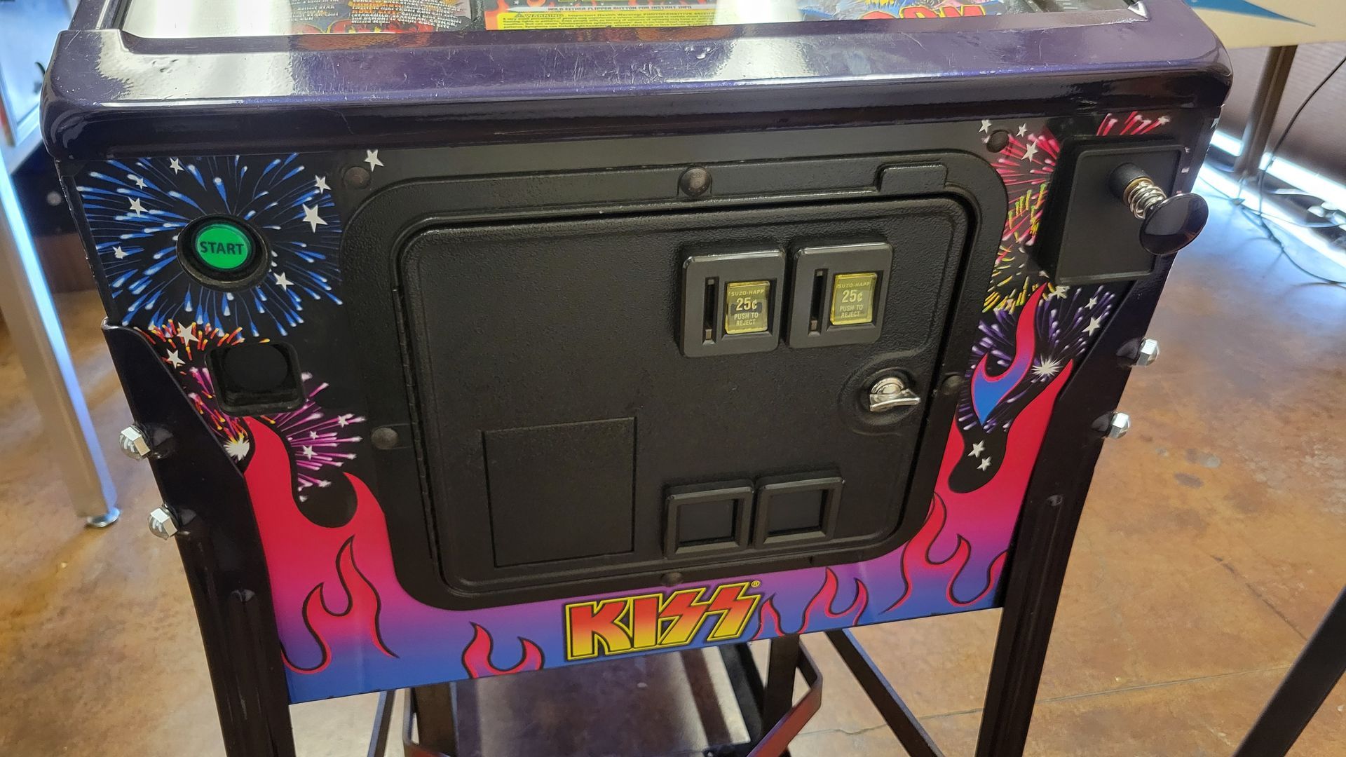 The back of a pinball machine with fireworks on it.
