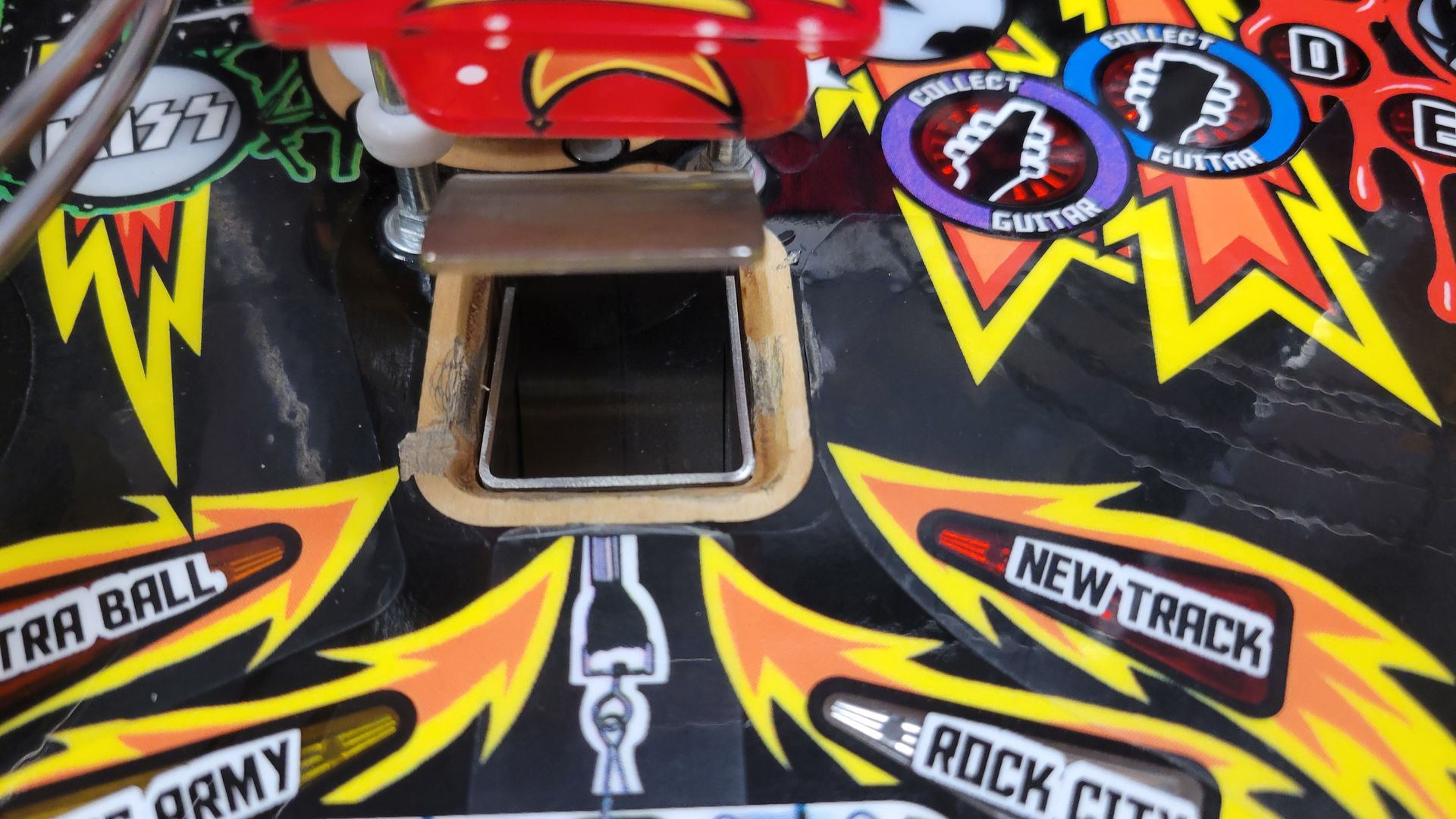 A close up of a pinball machine with new track written on it