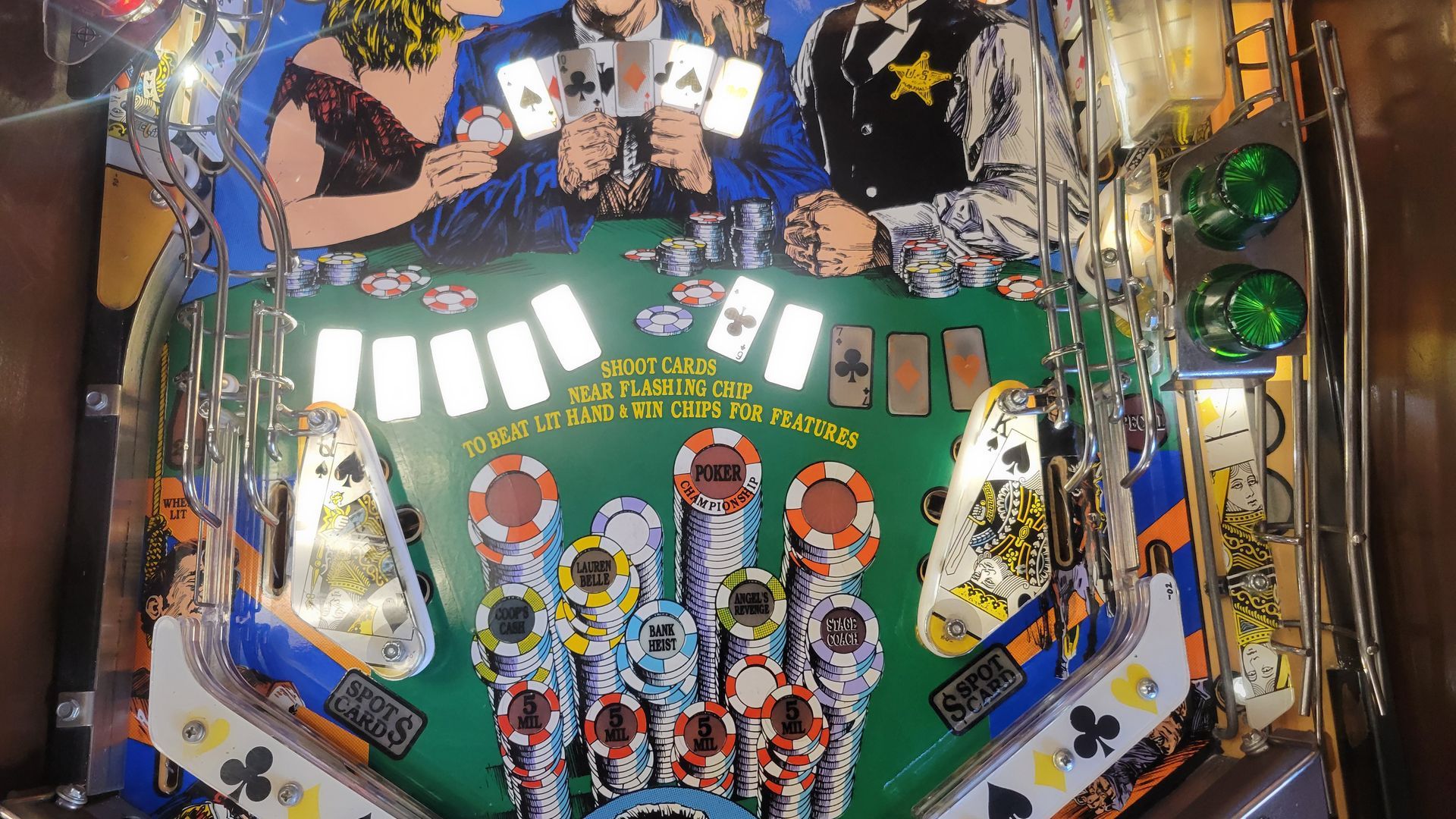 A pinball machine with cards and chips on it